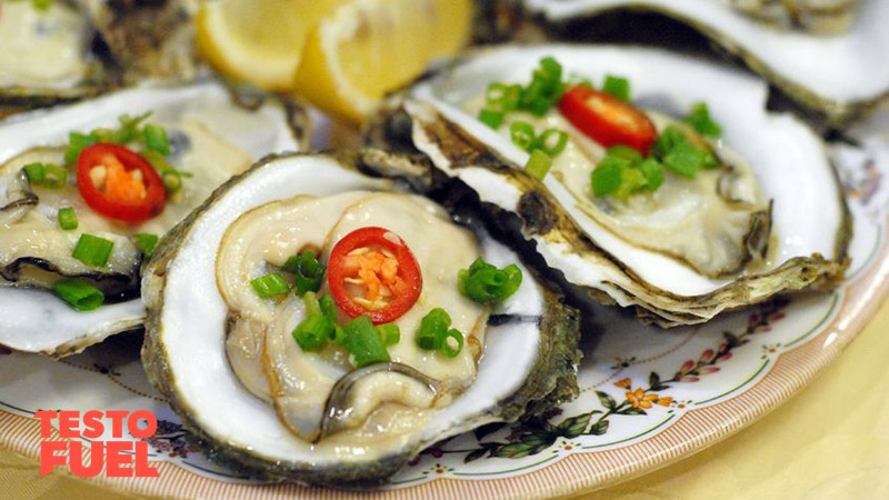 Oysters on a plate with a tomato and herb garnish