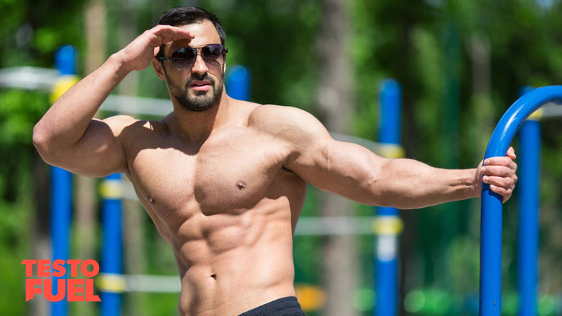 Strong, muscular bodybuilder with high testosterone levels training bodyweight in the park