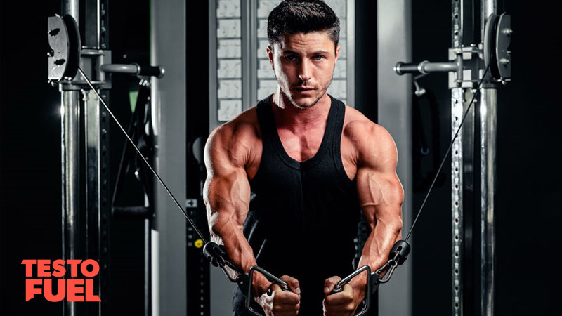 Young, athletic man doing cable crossovers to build chest muscles in the gym