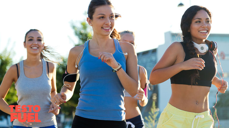 A small group of young, athletic women running outside