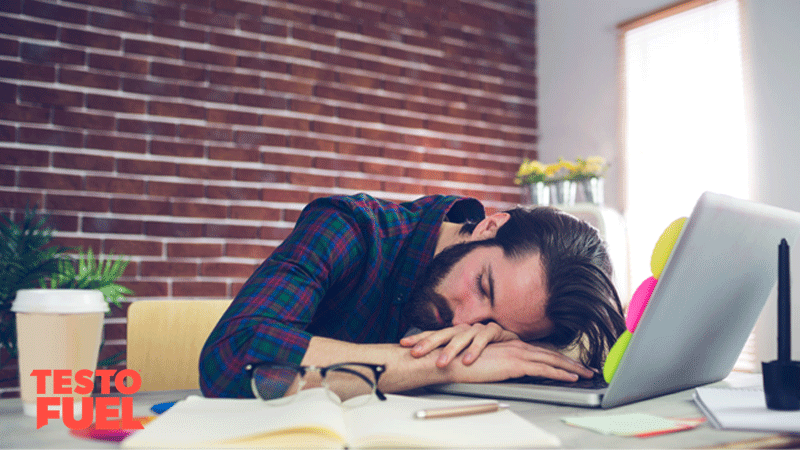 A tired businessman asleep at his desk 