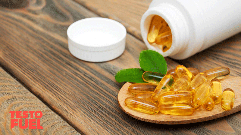 Vitamin d3 capsules in a spoon on a wooden background