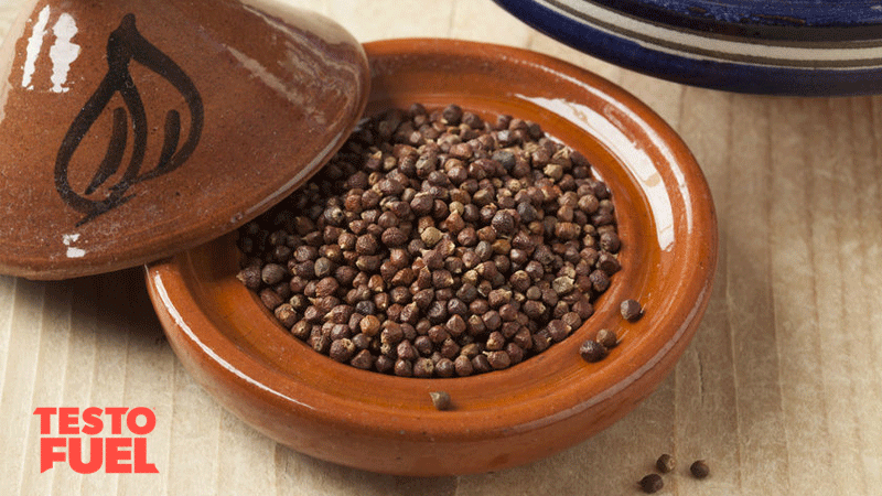 Aframomum melegueta seeds in a brown ceramic bowl