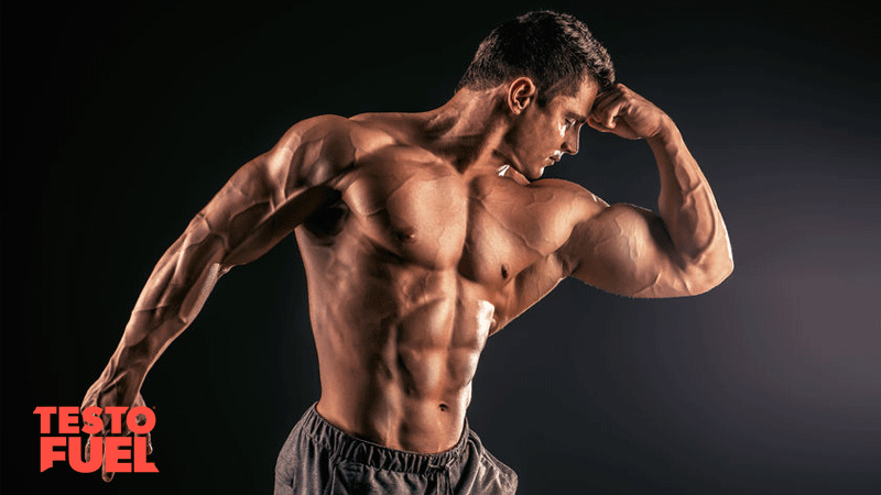 Muscular bodybuilder posing over black background