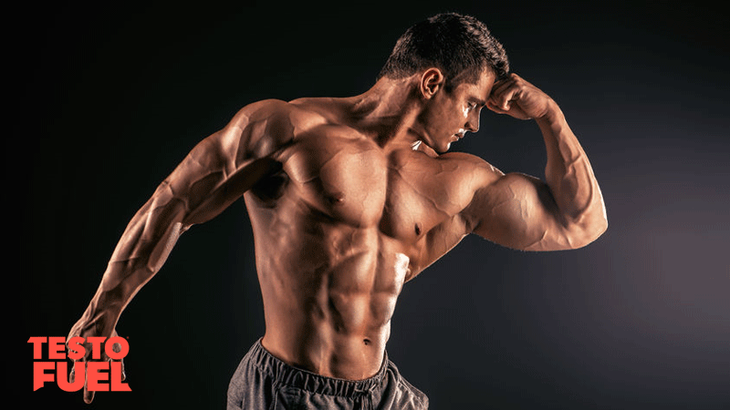 Handsome, athletic and muscular bodybuilder posing over black background