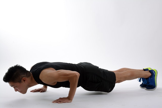 Man doing plank to stay healthy at home